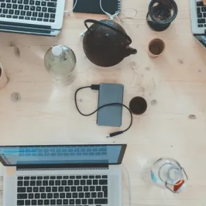 A bunch of laptops on a table from above