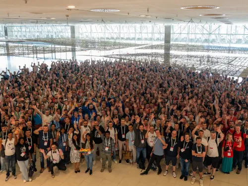 Large group of people at DrupalCon Barcelona 2024 posting for a group photo.