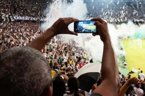 Person Taking Photo of Stage Stadium Presentation.
